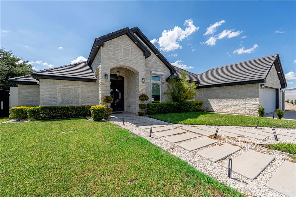 a front view of a house with a yard and garage