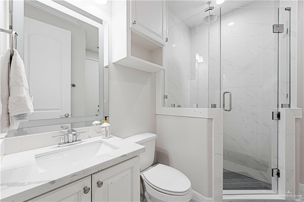 1208 Travis Street Mission, TX 78572 - Photo 17 of 41 a bathroom with a sink a toilet and shower