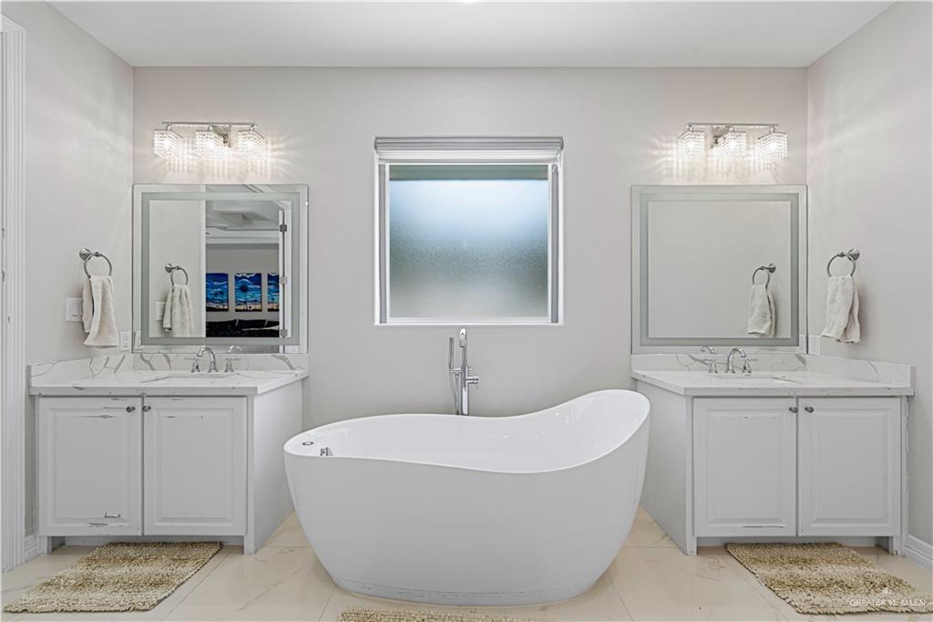1208 Travis Street Mission, TX 78572 - Photo 23 of 41 a bathroom with a tub sink and mirror