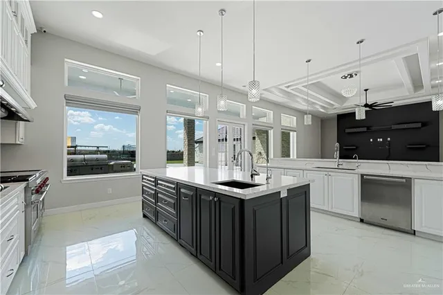 a kitchen with stainless steel appliances kitchen island granite countertop a sink and cabinets