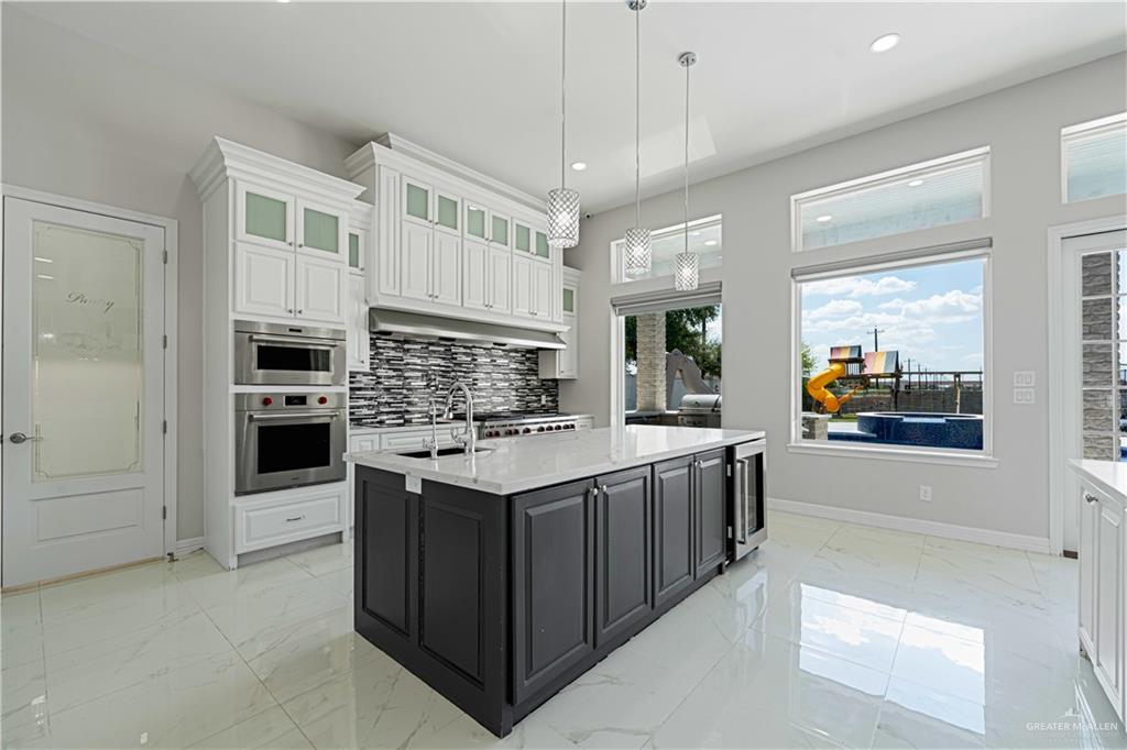 1208 Travis Street Mission, TX 78572 - Photo 32 of 41 a kitchen with stainless steel appliances granite countertop a stove and a refrigerator