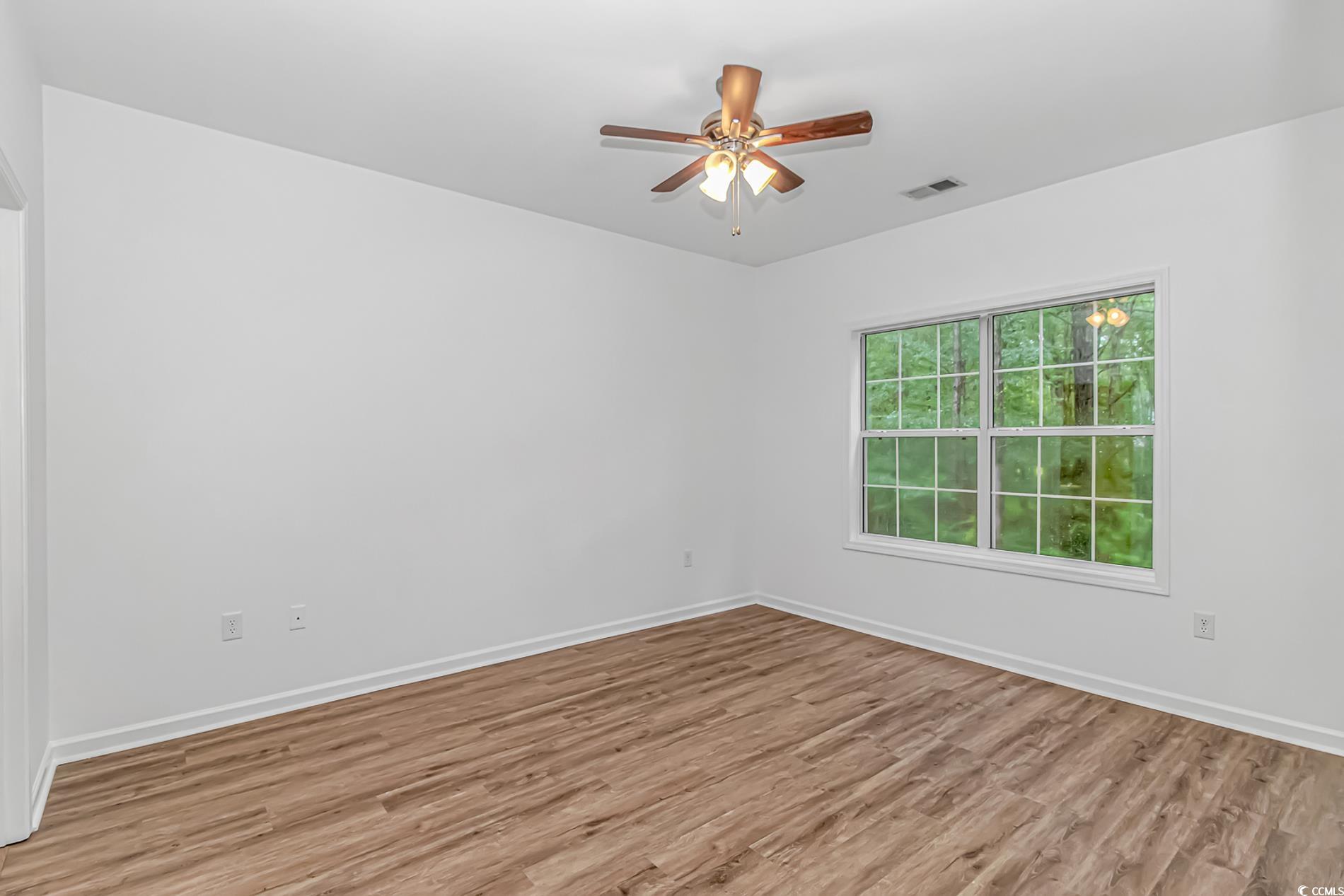 4814 Innisbrook Court, Unit 407 Myrtle Beach, SC 29579 - Photo 14 of 31 Empty room with light wood-style floors and ceiling fan