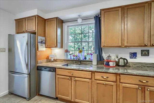 a kitchen with stainless steel appliances granite countertop a refrigerator sink and cabinets