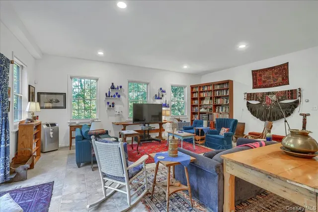 a living room with fireplace furniture and a large window