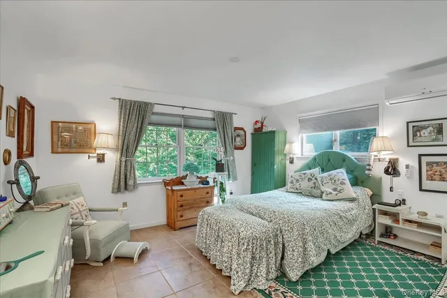 a bedroom with a bed couch and a window