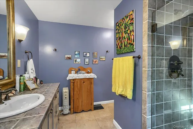 a bathroom with a sink mirror and tub