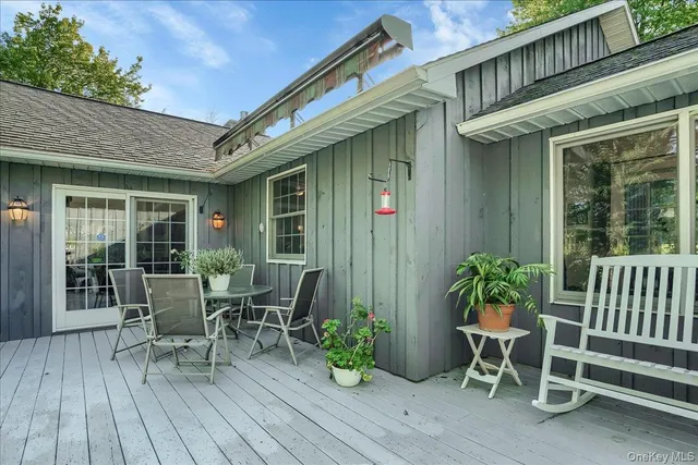 a view of a chair and table in patio of the house