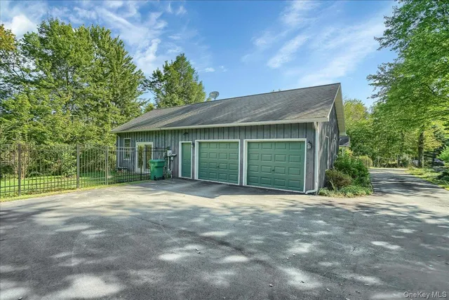a front view of a house with a garden and trees