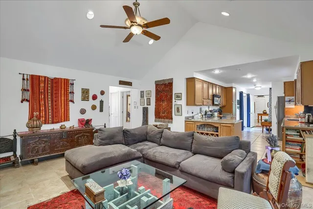 a living room with furniture kitchen view and a flat screen tv