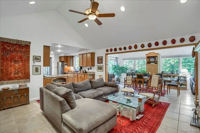a living room with furniture fireplace and a large window