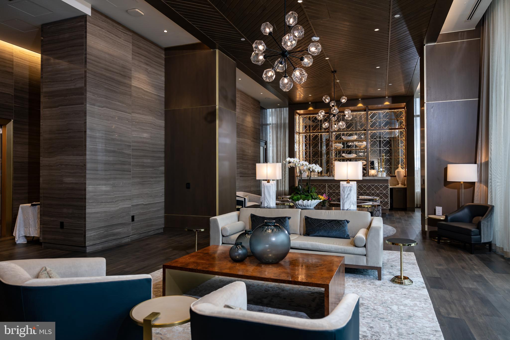 1911 Walnut Street, Unit 4302 Philadelphia, PA 19103 - Photo 8 of 20 a living room with furniture and a chandelier