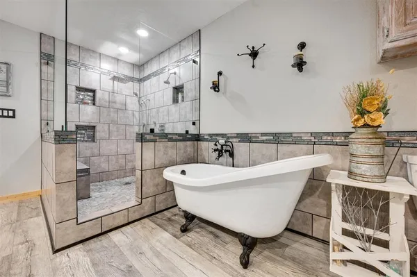 a bathroom with a bathtub and shower