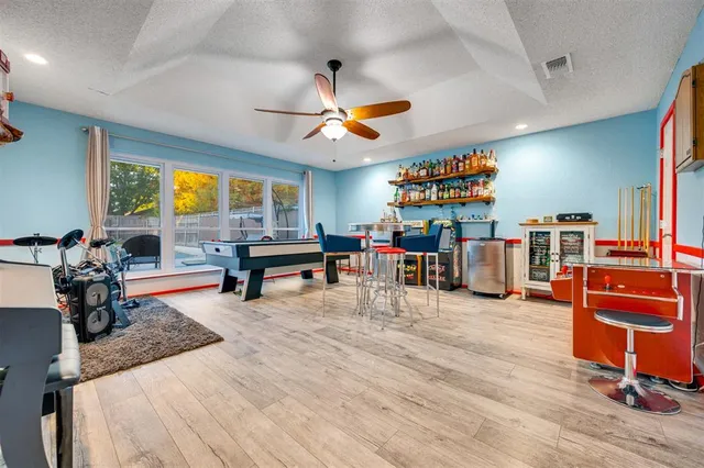 a living room with furniture and a flat screen tv with wooden floor
