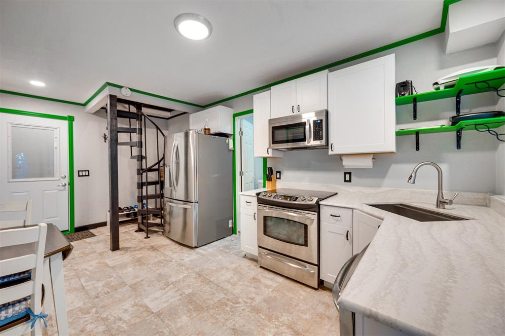 4115 Alpine Street Paris, TX 75462 - Photo 24 of 40 a kitchen with a sink stove and refrigerator