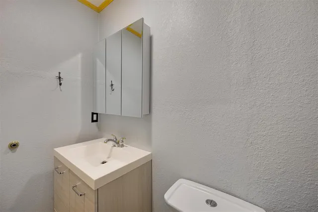 a bathroom with a toilet a sink and mirror