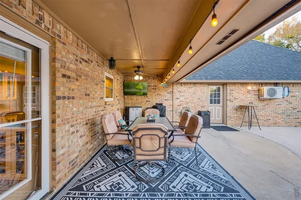 a balcony view with a table and chairs