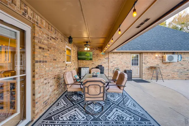 a balcony view with a table and chairs