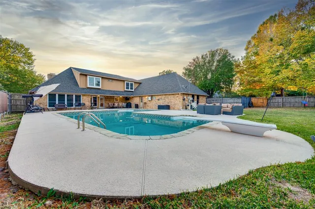 a view of house with yard and green space