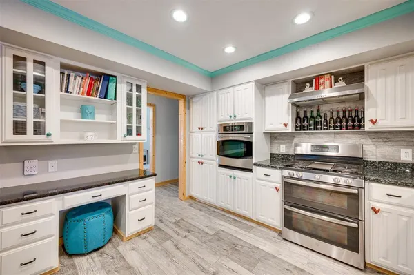 a kitchen with stainless steel appliances granite countertop a stove and a sink