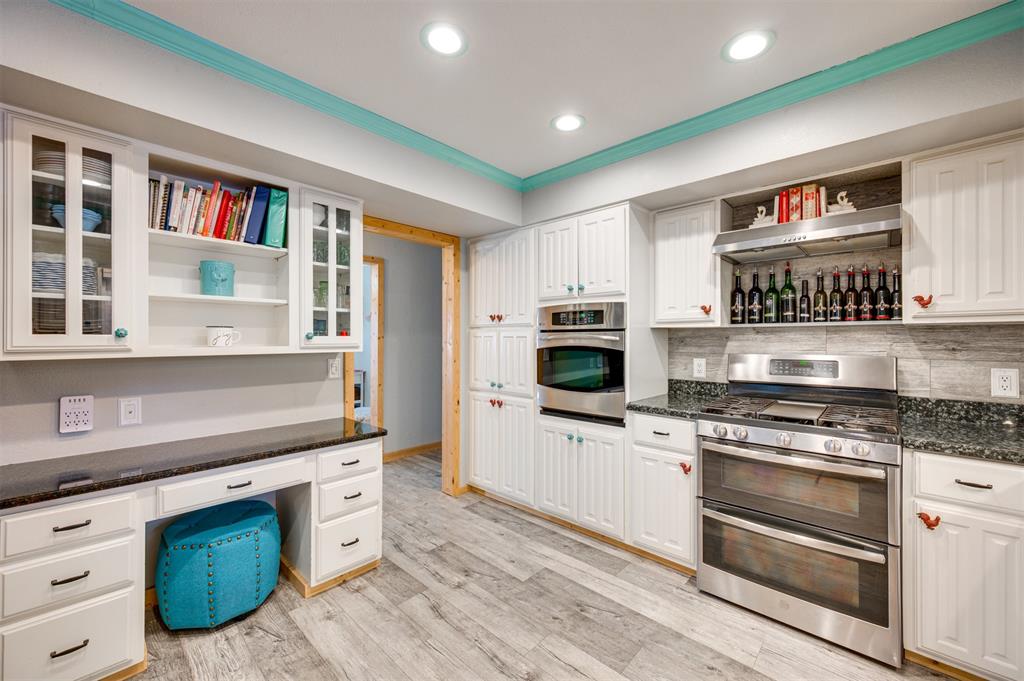 4115 Alpine Street Paris, TX 75462 - Photo 9 of 40 a kitchen with stainless steel appliances granite countertop a stove and a sink