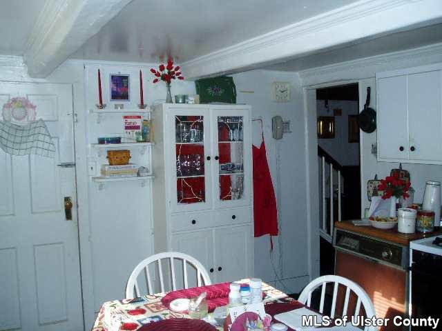 a bedroom with furniture a baby crib and a window