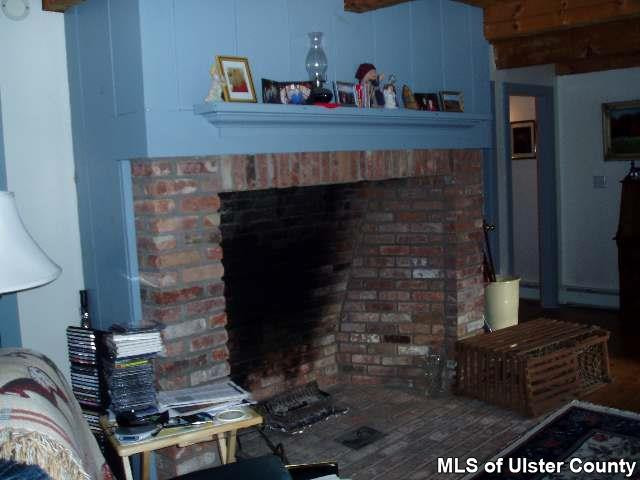 4543 Atwood Road Stone Ridge, NY 12484 - Photo 2 of 4 a living room with furniture and a fireplace