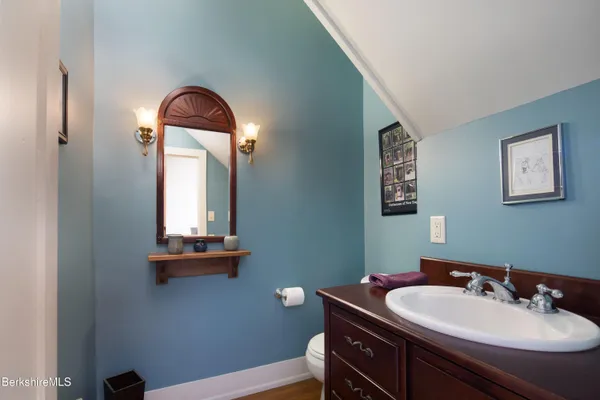 a bathroom with a sink a light fixture and a toilet