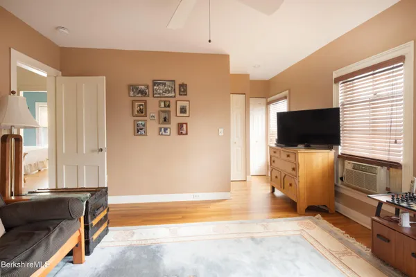 a living room with a flat screen tv a couch and a flat screen tv