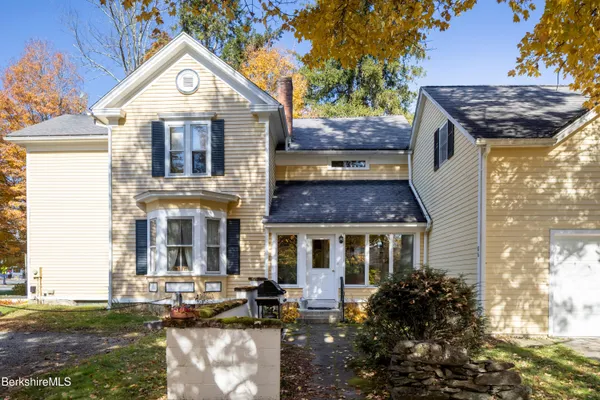 a front view of a house with swimming pool and porch