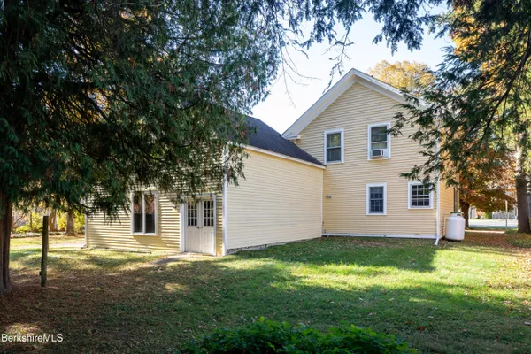 a house that has a tree in front of it
