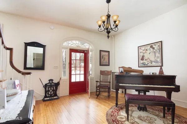 a living room with furniture and a chandelier