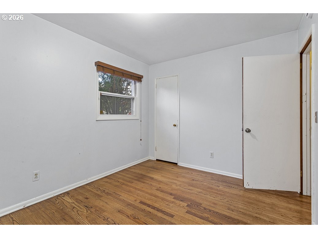 14035 Southeast Harrison Street Portland, OR 97233 - Photo 14 of 32 a view of an empty room with wooden floor
