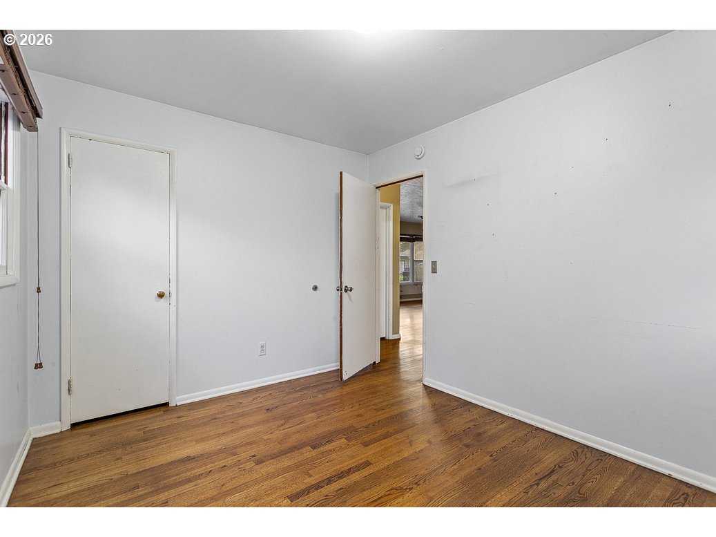 14035 Southeast Harrison Street Portland, OR 97233 - Photo 15 of 32 a view of an empty room with wooden floor