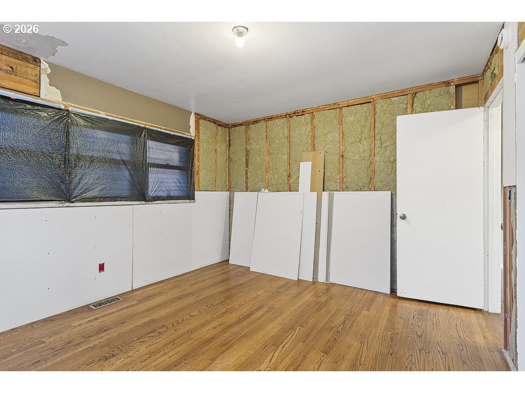 14035 Southeast Harrison Street Portland, OR 97233 - Photo 18 of 32 a view of an empty room with wooden floor