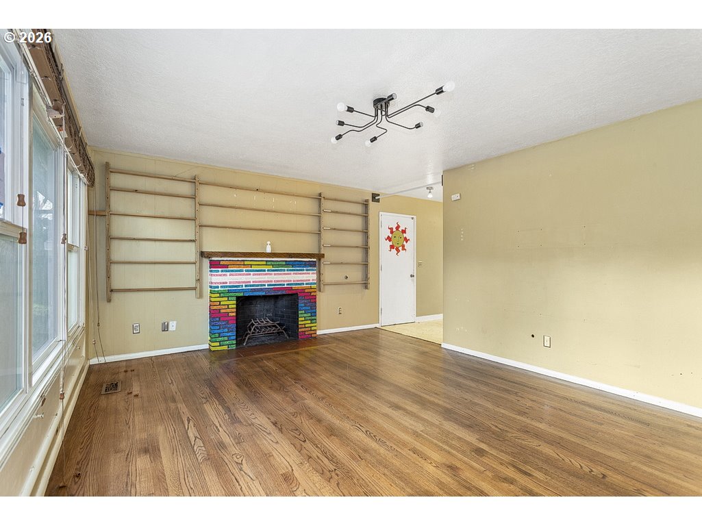 14035 Southeast Harrison Street Portland, OR 97233 - Photo 5 of 32 a view of an empty room with a fireplace and a window