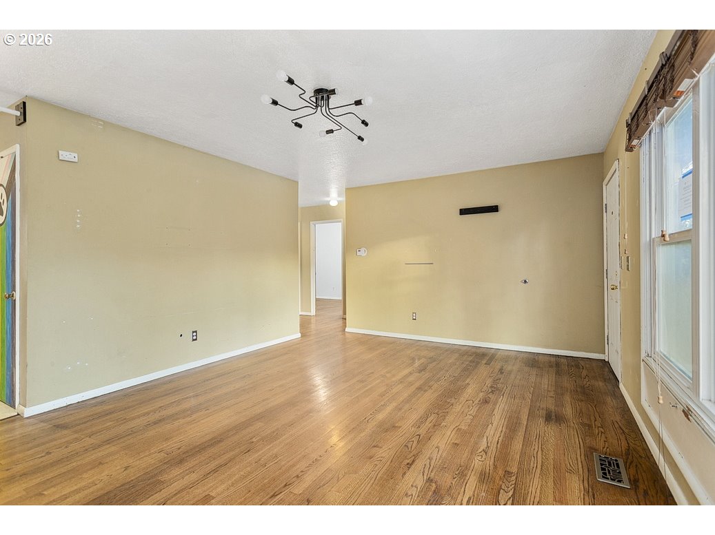 14035 Southeast Harrison Street Portland, OR 97233 - Photo 6 of 32 a view of an empty room with wooden floor