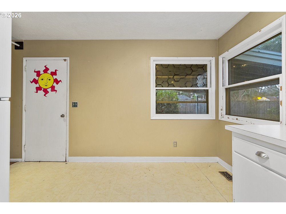 14035 Southeast Harrison Street Portland, OR 97233 - Photo 9 of 32 a view of an empty room with a window and refrigerator
