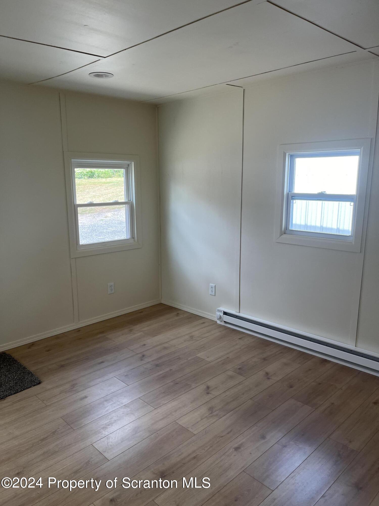 64 Franklin Street Great Bend, PA 18821 - Photo 29 of 33 an empty room with wooden floor and windows
