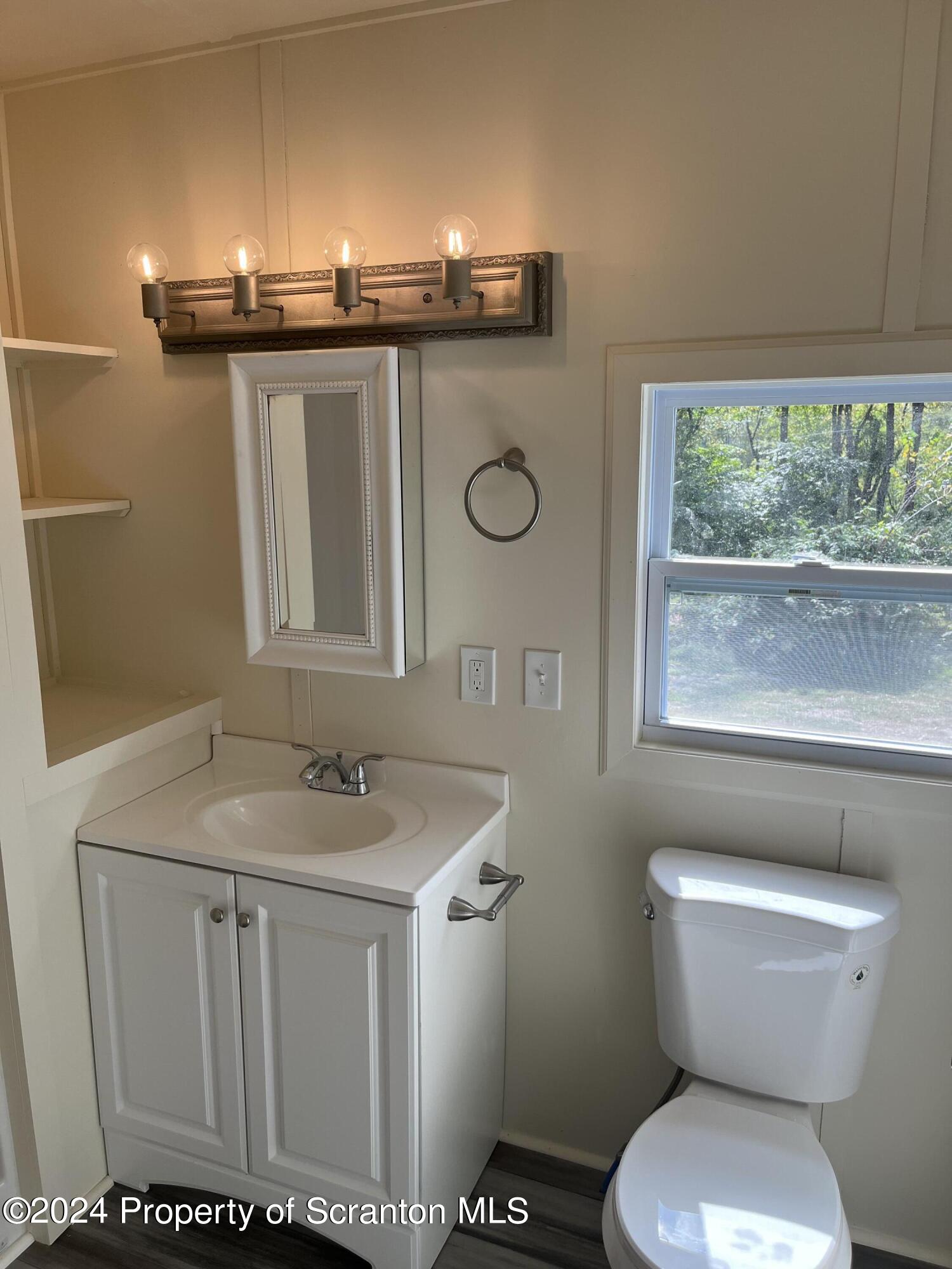64 Franklin Street Great Bend, PA 18821 - Photo 32 of 33 a bathroom with a sink a toilet and mirror