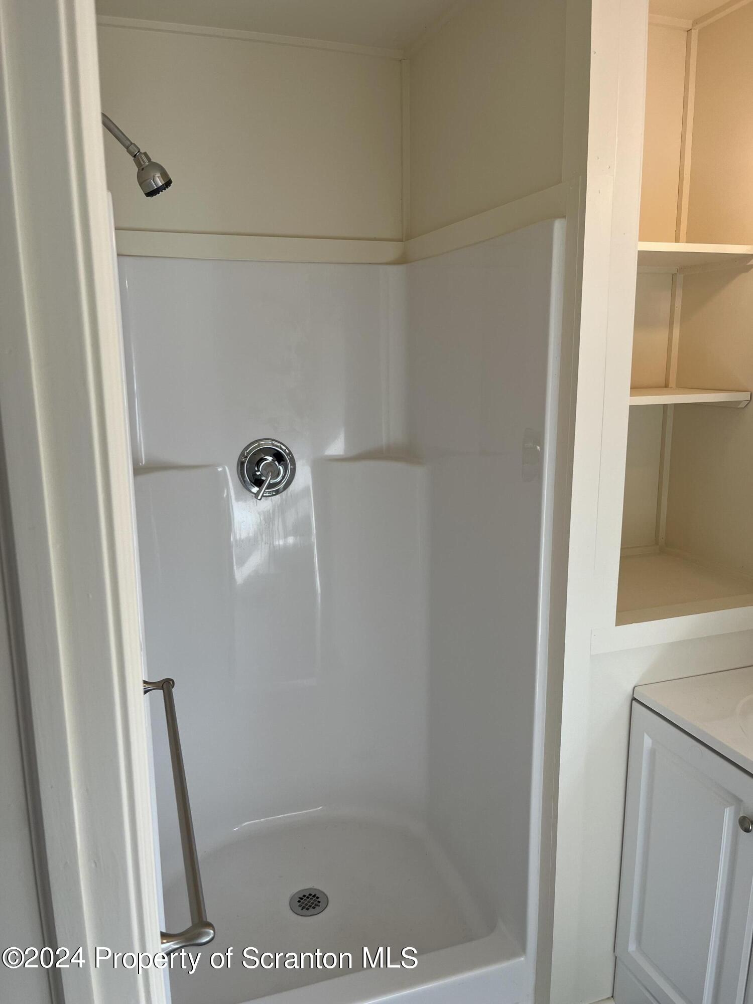 64 Franklin Street Great Bend, PA 18821 - Photo 33 of 33 a bathroom with a glass shower door