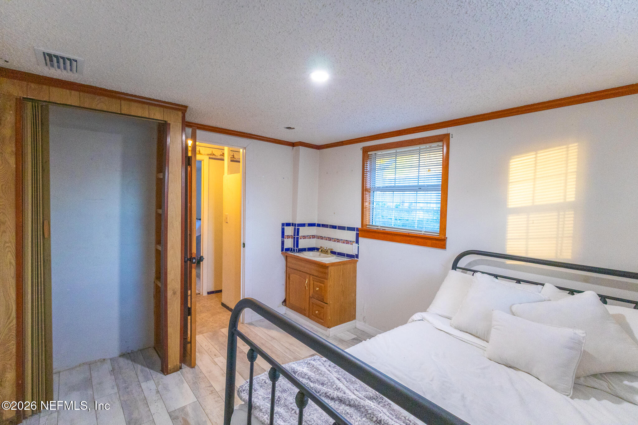 110 Jimmie Road Crescent City, FL 32112 - Photo 15 of 54 a bedroom with a bed and wooden floor