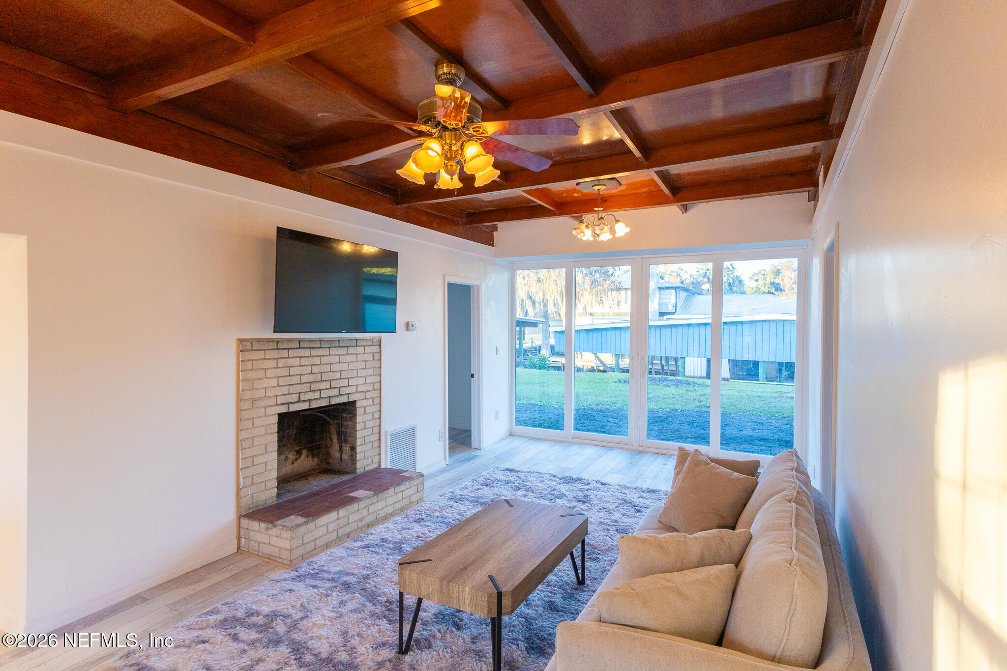 110 Jimmie Road Crescent City, FL 32112 - Photo 3 of 54 a living room with furniture a fireplace and a flat screen tv