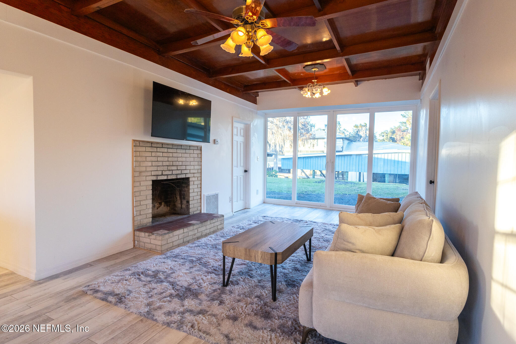 110 Jimmie Road Crescent City, FL 32112 - Photo 4 of 54 a living room with furniture a fireplace and a flat screen tv