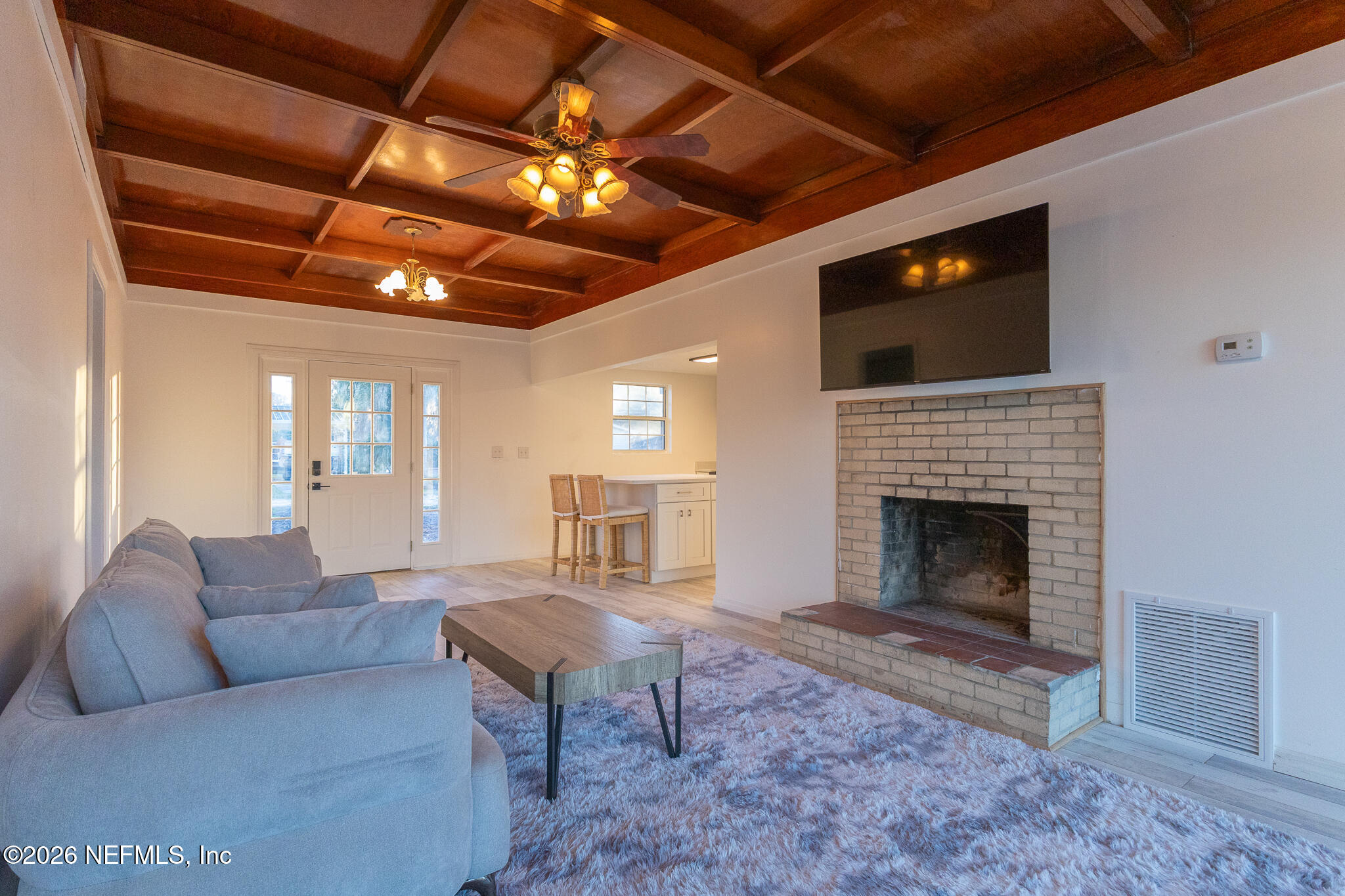 110 Jimmie Road Crescent City, FL 32112 - Photo 5 of 54 a living room with furniture a flat screen tv and a fireplace