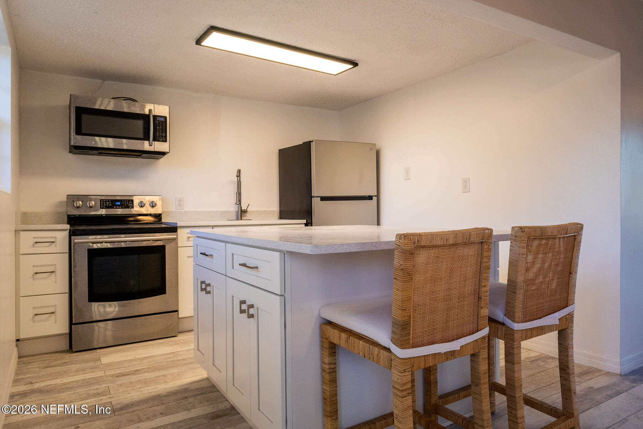 110 Jimmie Road Crescent City, FL 32112 - Photo 9 of 54 a kitchen with stainless steel appliances a stove microwave and cabinets