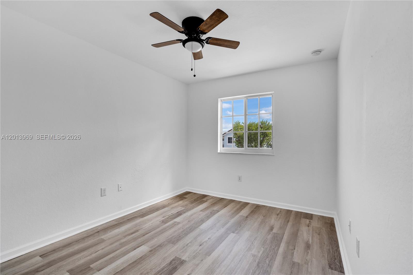 14044 Southwest 273rd Lane, Unit 14044 Homestead, FL 33032 - Photo 29 of 44 a view of empty room with wooden floor