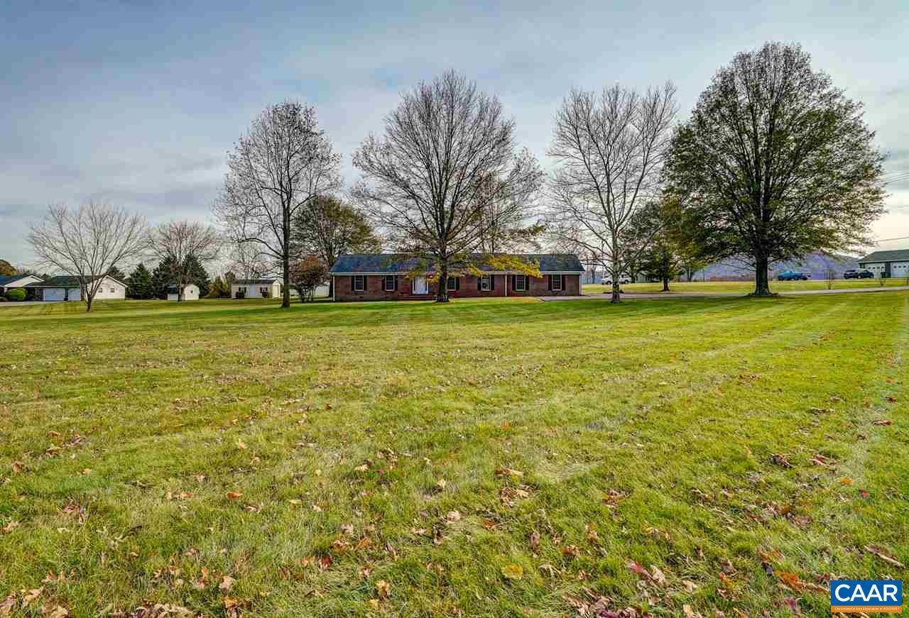 43 March Road Stanardsville, VA 22973 - Photo 3 of 26 a brick house with a big yard and large trees
