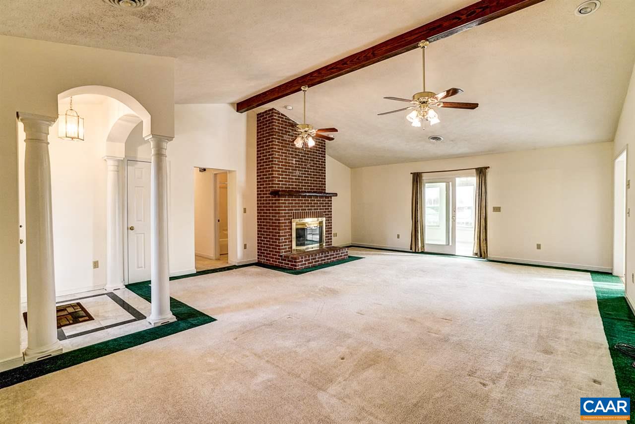 43 March Road Stanardsville, VA 22973 - Photo 7 of 26 a view of a livingroom with a fireplace and ceiling fan