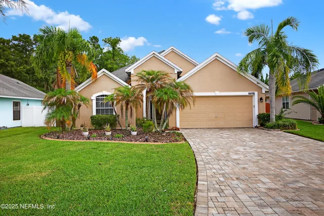 a front view of house with yard and green space
