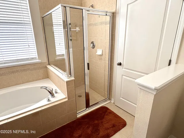 a bathroom with a bathtub and a shower